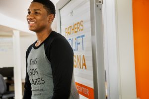 teenage boy standing in the Fathers Uplift doorway