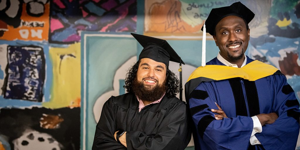 two man in graduation caps and gowns